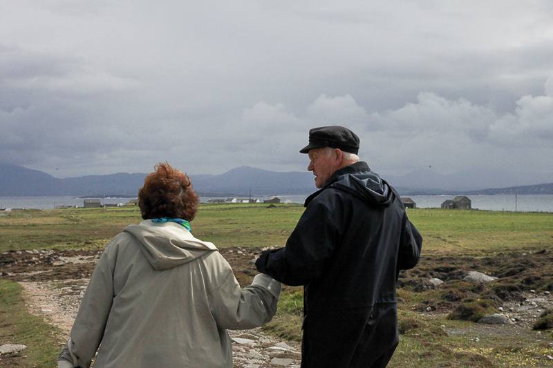 The King of Tory Island, Patsy Dan Rogers escorts Thin Places Tours guest on a walk across Tory Island