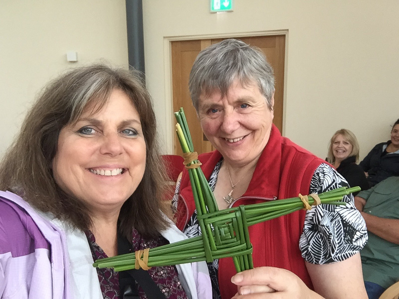 Mindie Burgoyne receives the St. Brigid's Cross from Sr. Phil